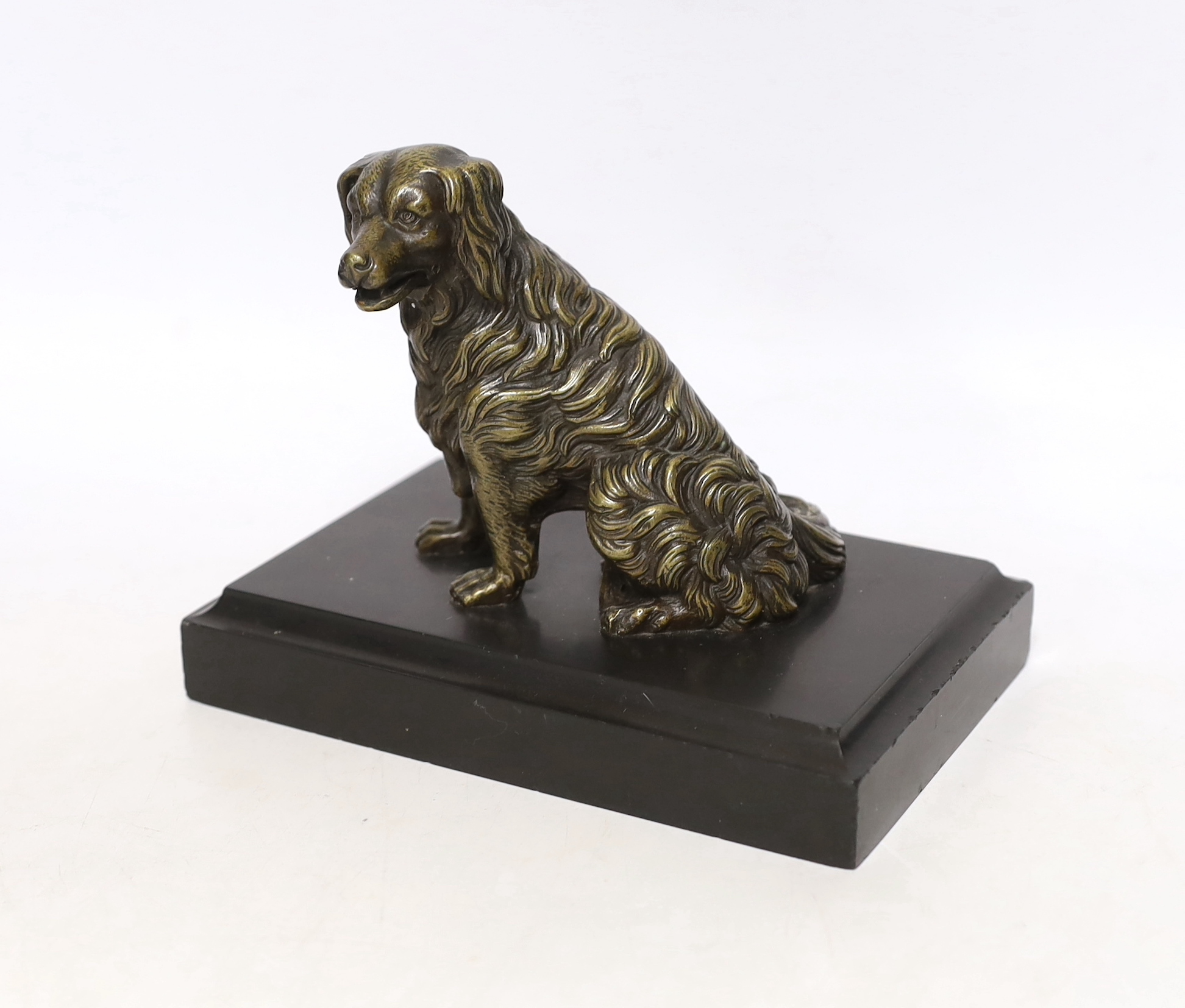 A 19th century French bronze dog card holder with articulated jaw, raised on a slate base, 18cm wide